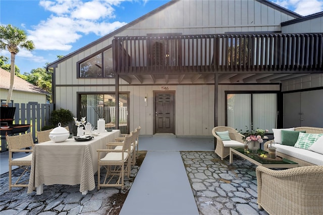 rear view of property featuring an outdoor hangout area and a patio area