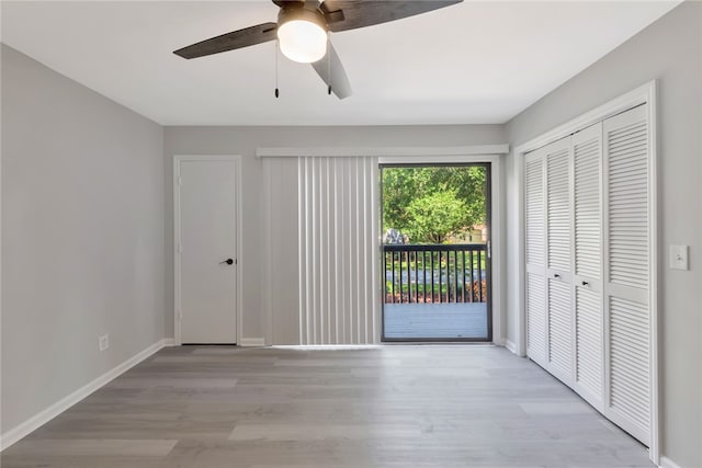 unfurnished bedroom with light hardwood / wood-style floors, ceiling fan, a closet, and access to outside