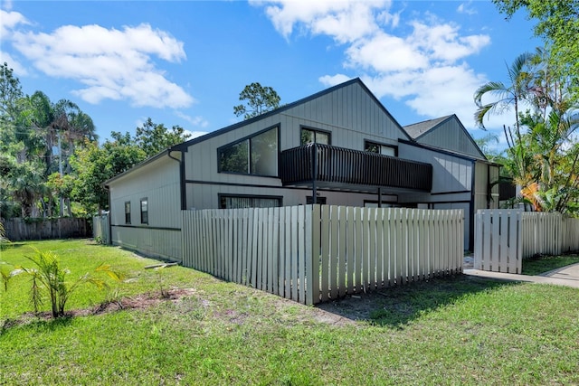 view of home's exterior featuring a yard and a balcony