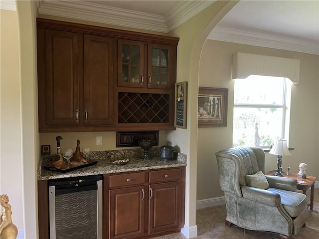 7633 Fieldstone Ranch Sq, Vero Beach, FL 32967 - indoor dry bar with wine cooler, crown molding, arched walkways, and tile patterned flooring