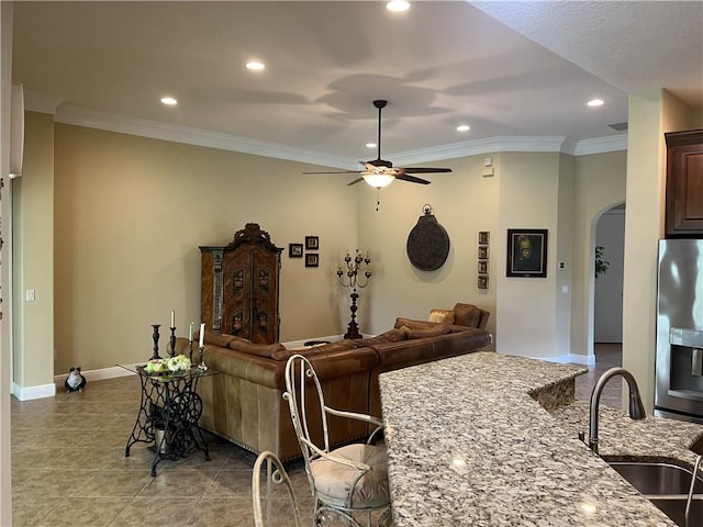 7633 Fieldstone Ranch Sq, Vero Beach, FL 32967 - tiled living area with arched walkways, recessed lighting, ceiling fan, and crown molding