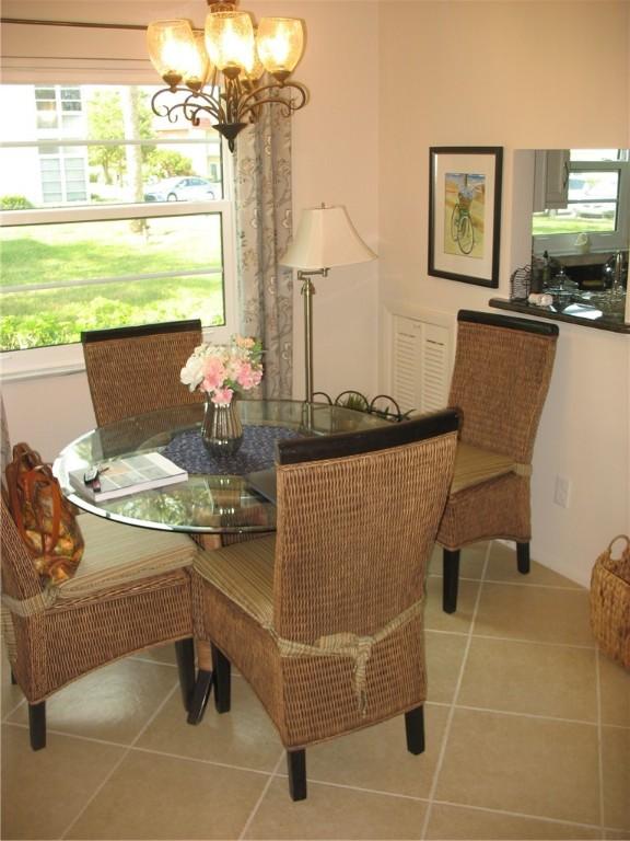 dining space with light tile patterned flooring and a chandelier