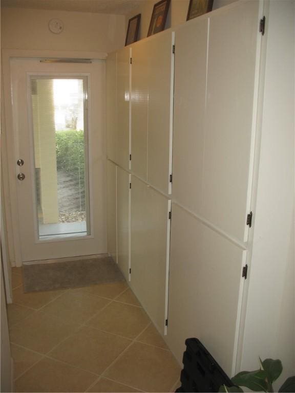 corridor with light tile patterned flooring