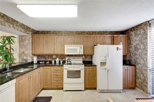 1480 Ocean Dr Unit 4C, Vero Beach, FL 32963 - kitchen with white appliances, wallpapered walls, dark stone countertops, a textured ceiling, and light tile patterned floors
