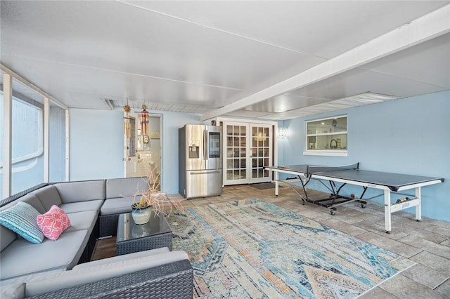 living room featuring french doors and beamed ceiling