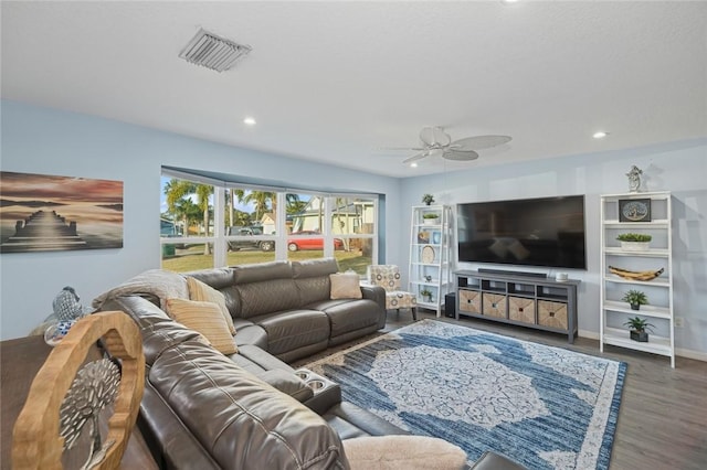 living room with ceiling fan and dark wood-type flooring