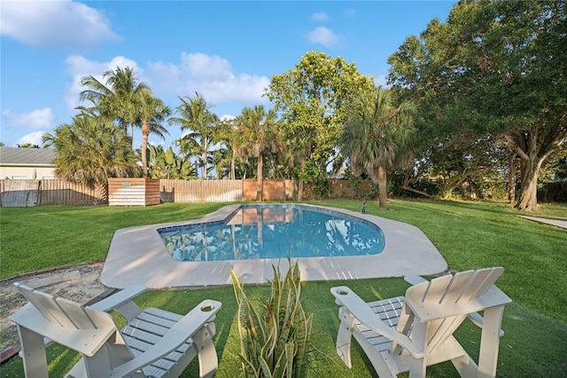 view of swimming pool with a lawn