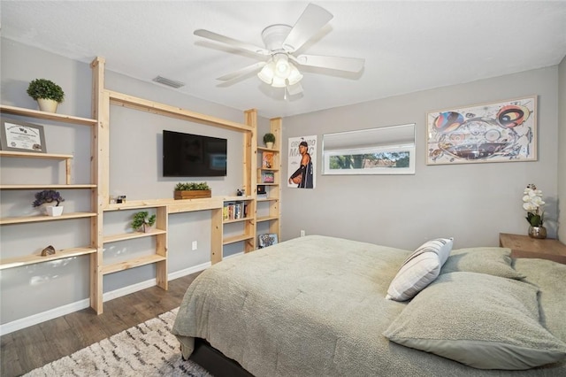 bedroom with ceiling fan and dark wood-type flooring