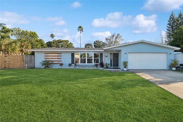 single story home featuring a front yard and a garage