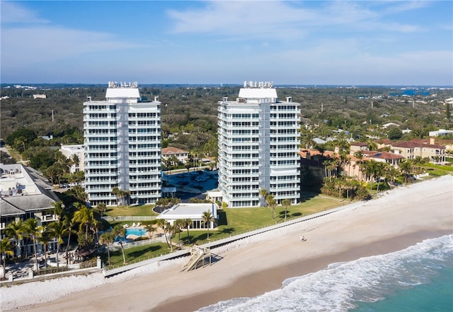 drone / aerial view with a beach view and a water view