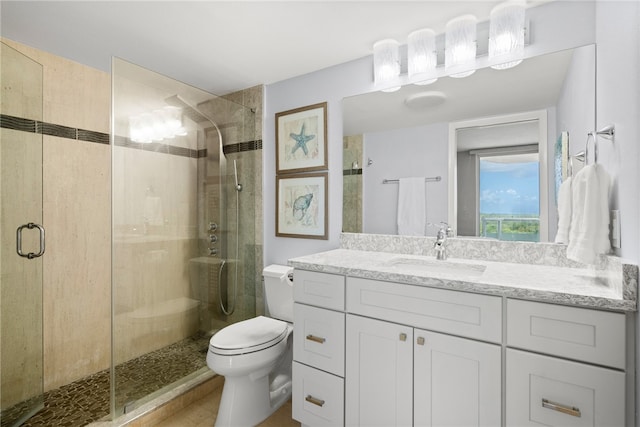 bathroom with walk in shower, vanity, and toilet