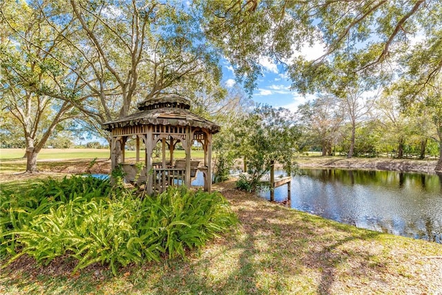 view of dock with a gazebo and a water view