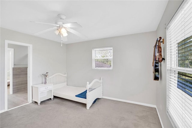 bedroom featuring light carpet and ceiling fan