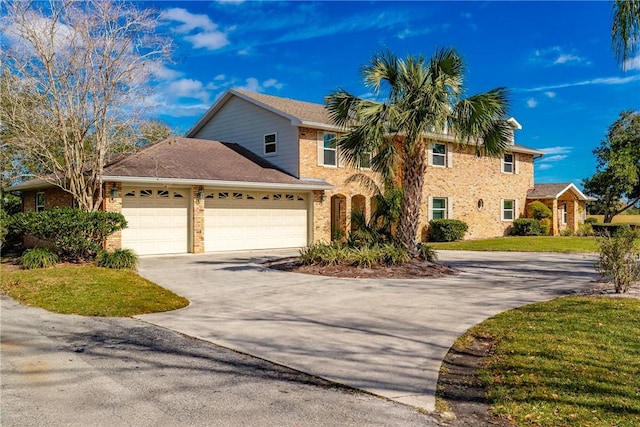 view of front of house with a garage and a front lawn