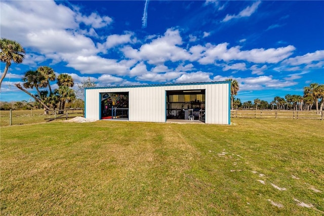 view of outbuilding with a yard and a rural view