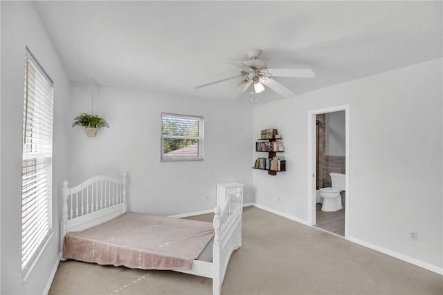 bedroom featuring ceiling fan, ensuite bath, and carpet