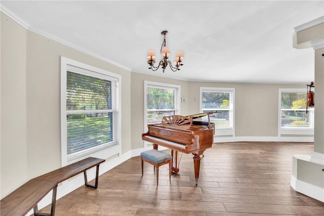 misc room with a notable chandelier, hardwood / wood-style flooring, and ornamental molding