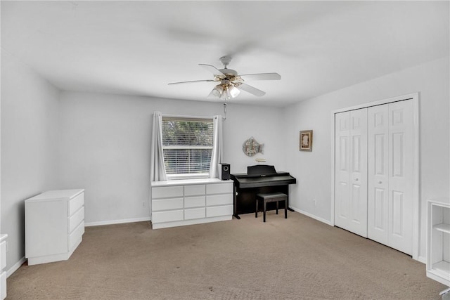 miscellaneous room featuring ceiling fan and light carpet