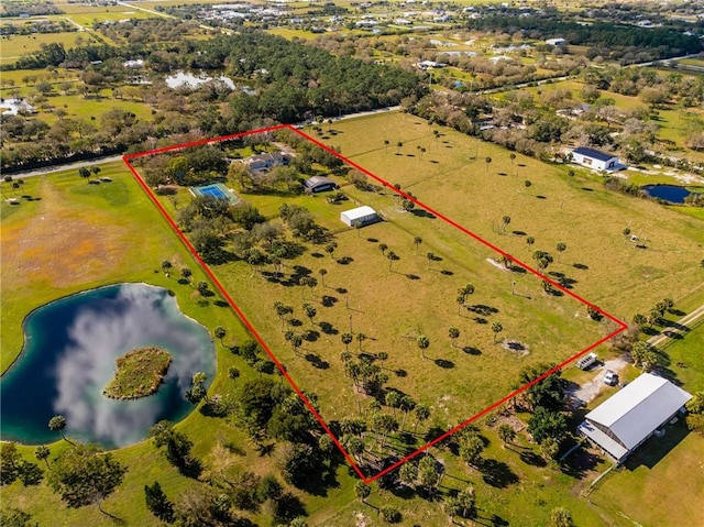 birds eye view of property with a water view and a rural view