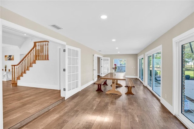 6500 1st St SW, Vero Beach, FL 32968 - dining space featuring french doors, baseboards, wood finished floors, and stairs