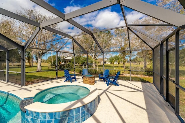 view of swimming pool with a yard, a patio, glass enclosure, an outdoor fire pit, and an in ground hot tub