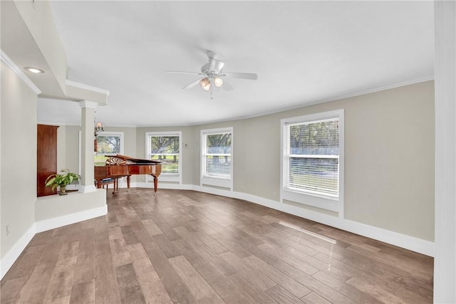 spare room featuring light hardwood / wood-style flooring, ornamental molding, and ceiling fan