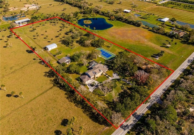 birds eye view of property with a water view and a rural view