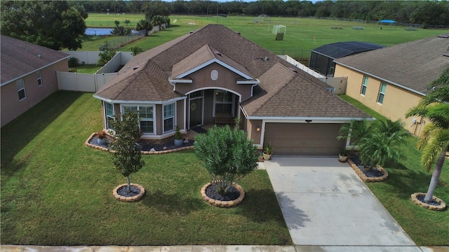 view of front of property featuring a garage and a front lawn