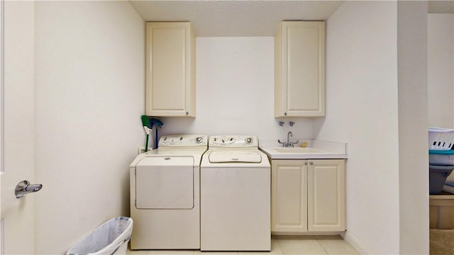 laundry room with sink, cabinets, independent washer and dryer, and light tile patterned flooring