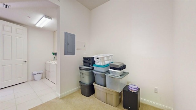 washroom featuring light colored carpet, electric panel, and washer and clothes dryer