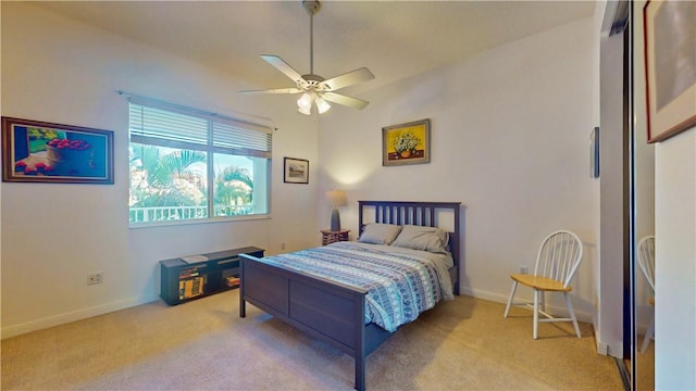 bedroom featuring light colored carpet and ceiling fan