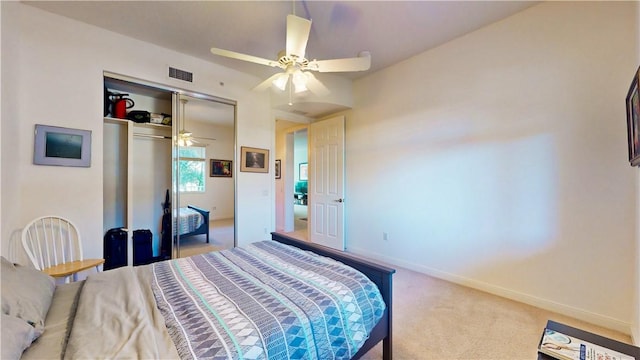 carpeted bedroom featuring ceiling fan and a closet