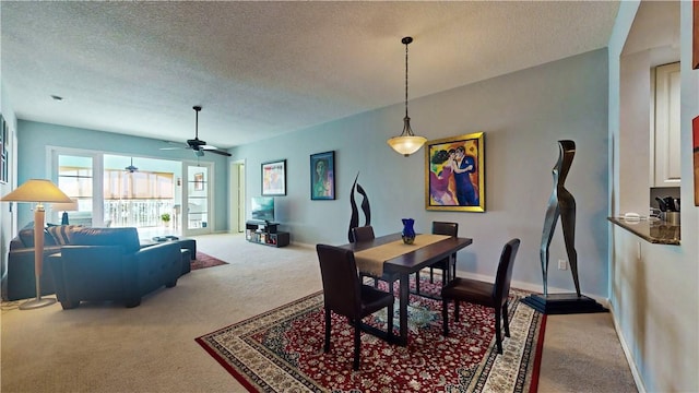 carpeted dining space featuring a textured ceiling