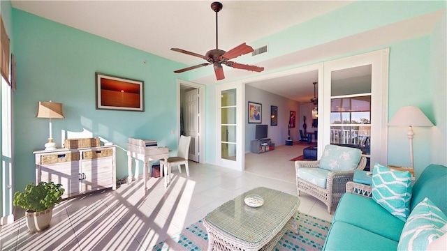 tiled living room with french doors and ceiling fan