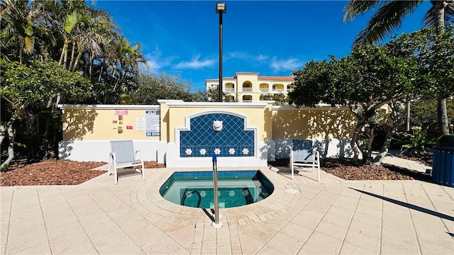 exterior space with a hot tub and a patio area