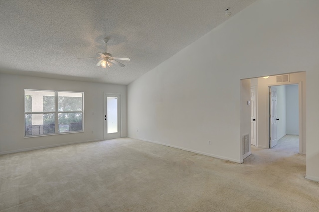 carpeted spare room with ceiling fan, a textured ceiling, and vaulted ceiling