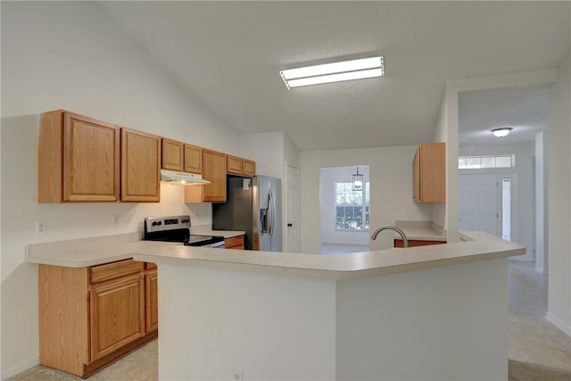 kitchen featuring range with electric cooktop, vaulted ceiling, kitchen peninsula, a textured ceiling, and stainless steel fridge