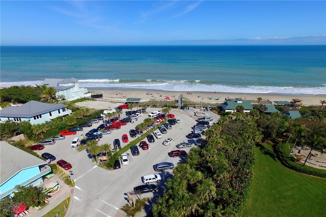 birds eye view of property with a view of the beach and a water view