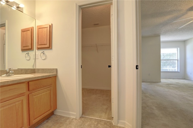 bathroom featuring vanity, a textured ceiling, and tile patterned floors