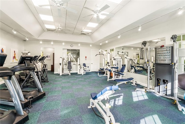 workout area featuring a paneled ceiling and ceiling fan