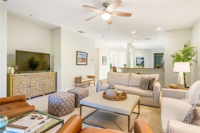 living room featuring light carpet and ceiling fan