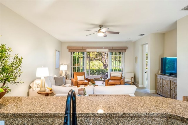 carpeted living room with ceiling fan