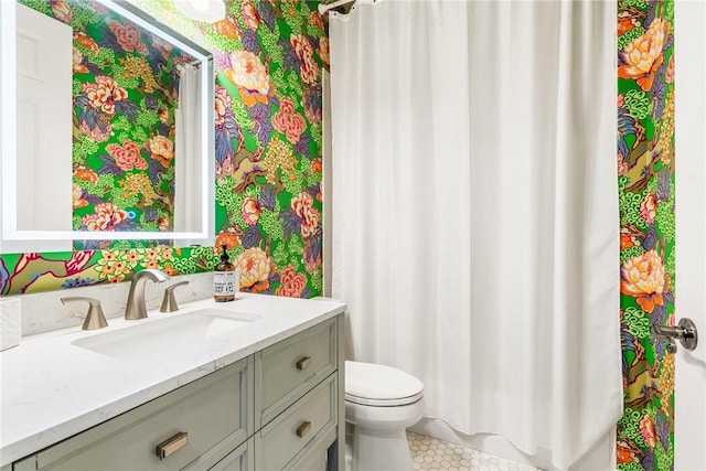 bathroom featuring vanity and toilet