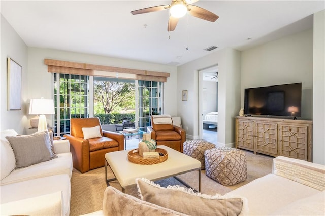 carpeted living room featuring ceiling fan