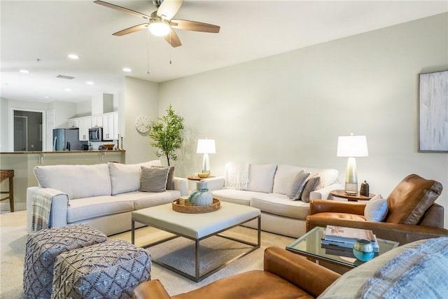 carpeted living room featuring ceiling fan