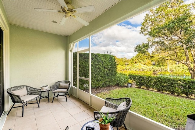 sunroom featuring ceiling fan