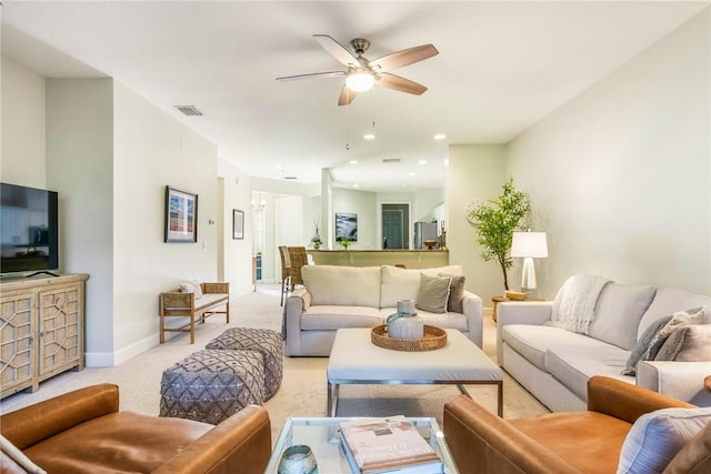 living room featuring ceiling fan and light carpet