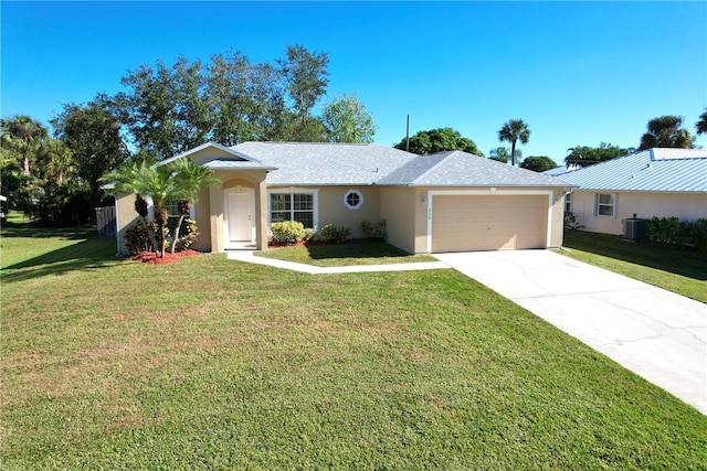 ranch-style house featuring central AC unit, a garage, and a front lawn