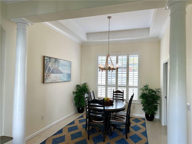 dining area with a chandelier, tile patterned flooring, a raised ceiling, and decorative columns