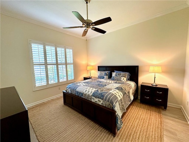 bedroom with ceiling fan, crown molding, baseboards, and wood finished floors